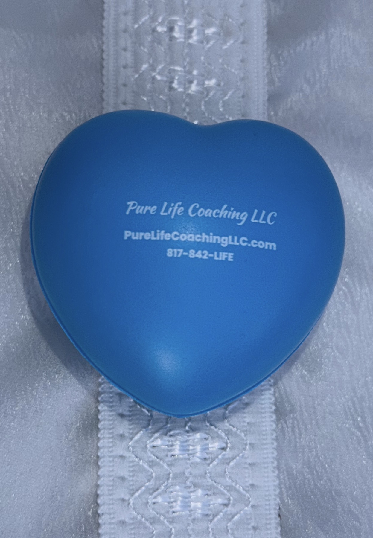 Blue heart-shaped squishy with Pure Life Coaching LLC branding